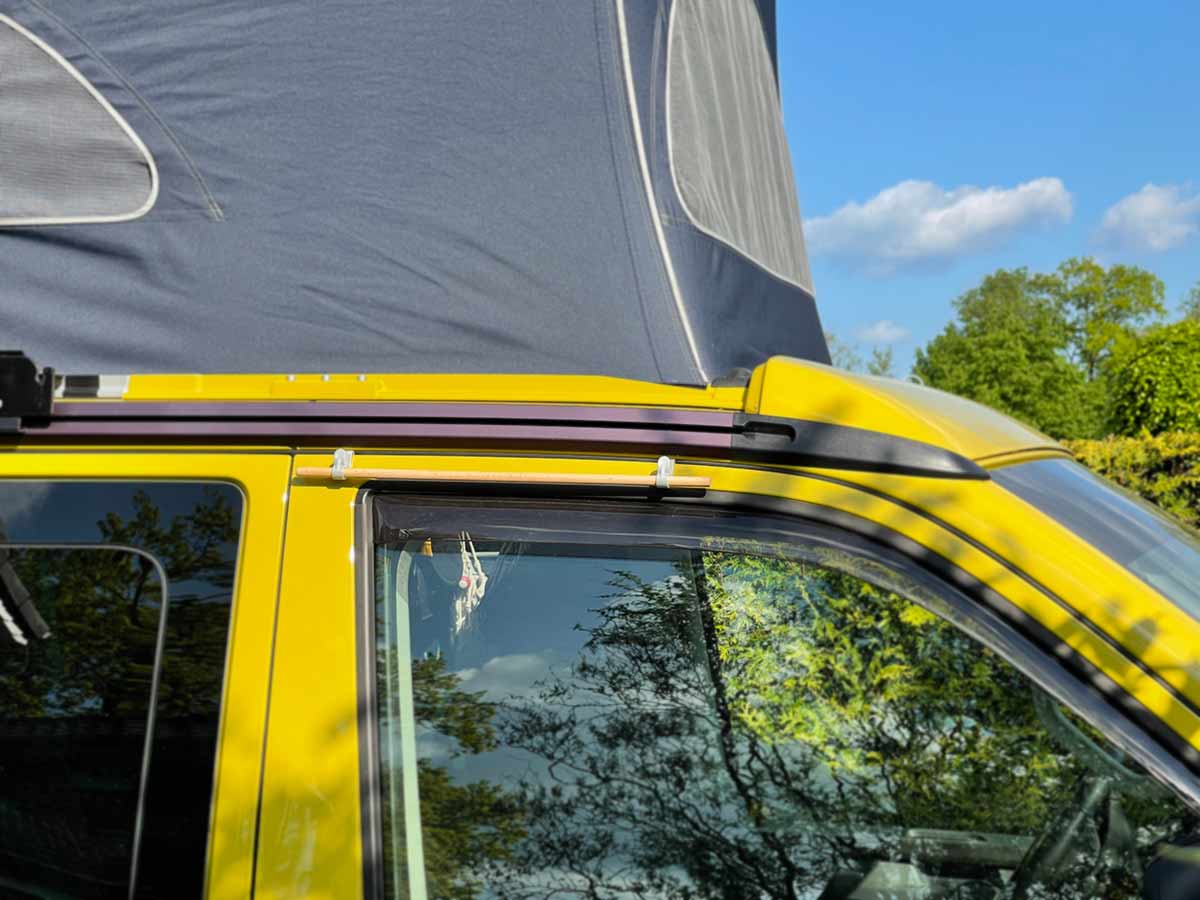 Two coat hooks and a clothes rail with KLEMMT on the door of the VW California Two coat hooks and a clothes rail with KLEMMT on the door of the VW California