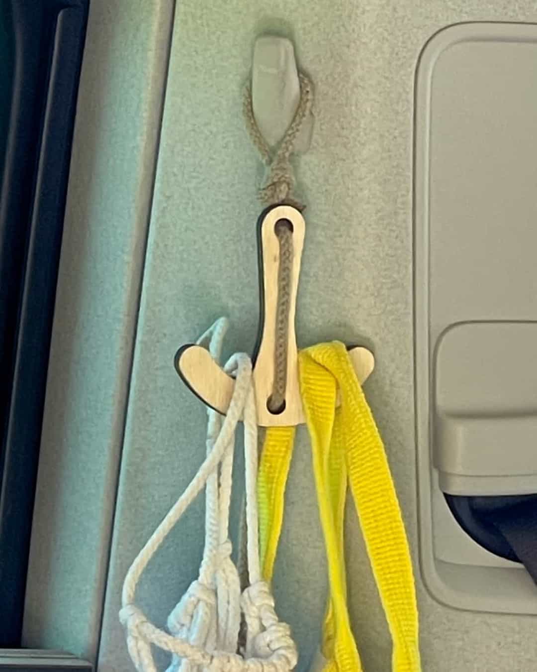 Doppelhaken hängt am Kleiderhaken Am Kleiderhaken im Van hängt der Doppelhaken mit Makramee Netz und Einkaufstasche.