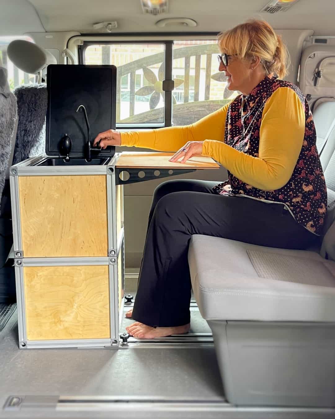 A module with sink and folding table is used in the van.